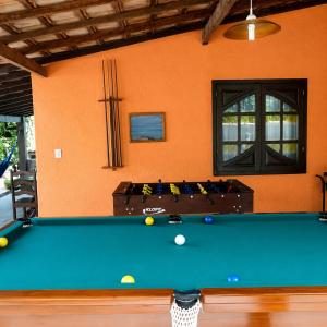 a pool table in front of a house at Pousada Viva Mar in Saquarema