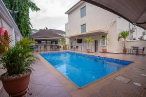a swimming pool in front of a house at Amber Residence GRA Ikeja in Ikeja