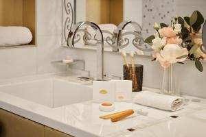 a bathroom counter with a sink and a mirror at Mandarin Oriental, Paris in Paris