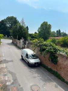 a white van parked next to a brick wall at Antica Dimora Confine in Mira +16 photos