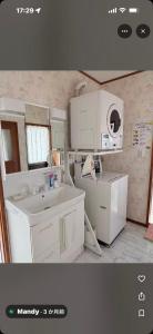 a white kitchen with a sink and a microwave at 富士山を眺められる宿 ゲストハウス花水木 in Nishikatsuracho +48 photos