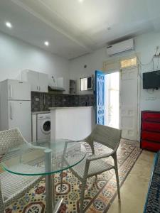 a kitchen with a glass table and chairs in it at blue house in Carthage