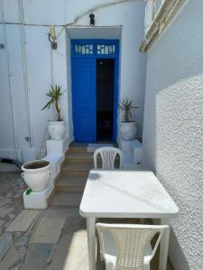 a blue door with a table and chairs in a building at blue house in Carthage +8 photos