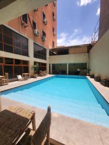 a large swimming pool in front of a building at Apart Hotel Larabi in Marrakesh