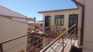 a balcony view of a house with a staircase at Hostal Churuquella in Sucre