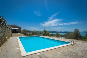 a swimming pool in a house with a view of the water at PoloTuristicoUmbria Rustico con Piscina Vista Lago in Passignano sul Trasimeno