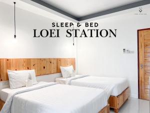 two beds in a room with a sign that reads sleep and bed lease station at Loei Station in Loei