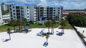 an aerial view of a resort with chairs and palm trees at Caprice 401 in St. Pete Beach
