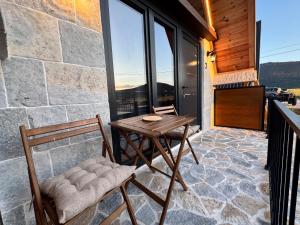 a table and chairs on the balcony of a house at Etno House Dragas in Njegovuđa +19 photos