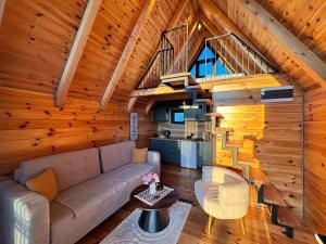 a living room with a couch and a staircase at Etno House Dragas in Njegovuđa