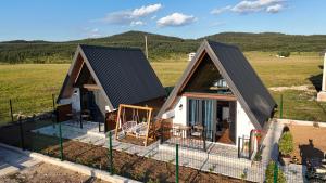 an overhead view of a house with a fence at Etno House Dragas in Njegovuđa