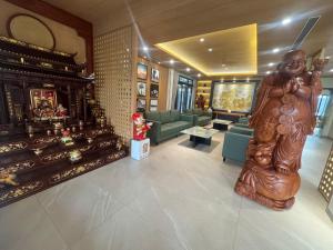 a living room with a statue in the middle of the room at Luxury 79 Hotel Hải Phòng in Hai Phong +8 photos