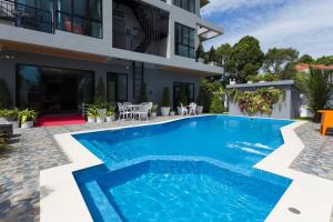a swimming pool in front of a house at The Lucky Beach Ao Nang in Ao Nang Beach