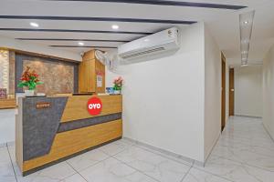 an office lobby with a stop sign on the counter at Hotel O Max Inn in Ahmedabad