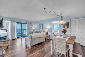 a living room with a dining room and a living room with a table at Caprice 501 in St. Pete Beach +56 photos