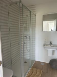 a glass shower in a bathroom with a sink at Mar de Queiruga: 12 Nadelas in Porto do Son