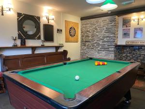 a pool table with balls on it in a room at The Globe Inn in Kingsbridge