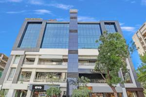 an office building with a sign on it at Hotel O Max Inn in Ahmedabad