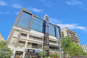 an office building with a sign on it at Hotel O Max Inn in Ahmedabad