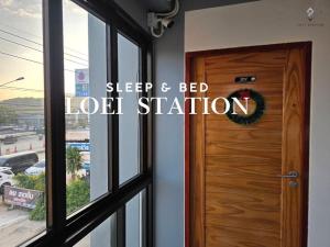 a wooden door with the words sleep and bed lot station at Loei Station in Loei