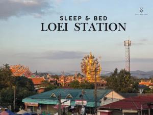 a sign that reads sleep and bed lot station with a city at Loei Station in Loei