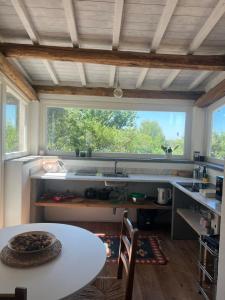 a kitchen with a table and a sink and a window at Il Respiro degli Ulivi in Viterbo