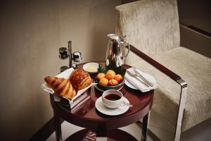 a table with a tray of food and a cup of coffee at Mandarin Oriental, Paris in Paris