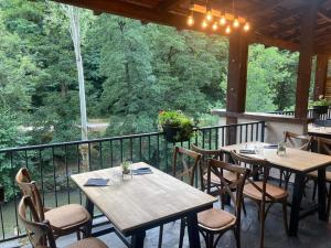 a patio with tables and chairs on a porch at Le Terminus in Ax-les-Thermes