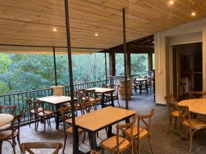 a restaurant with tables and chairs on a balcony at Le Terminus in Ax-les-Thermes