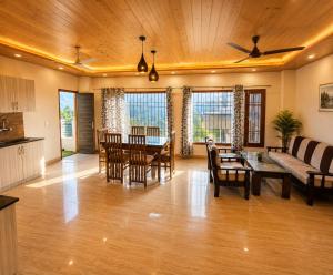 a living room with a couch and a table at Dharvi Kasauli Heavens in Kasauli