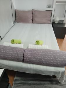 a bed with two towels and two pillows on it at Апартаменти Viviana in Plovdiv +187 photos