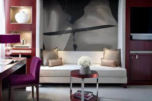 a living room with a white couch and a table at Mandarin Oriental, Paris in Paris