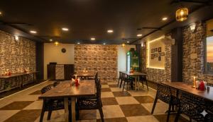 a restaurant with tables and chairs and a checkered floor at Jaipur Grand Bella in Jaipur