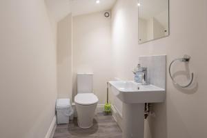 a white bathroom with a sink and a toilet at Finest Retreats - Field View in Brackley +9 photos