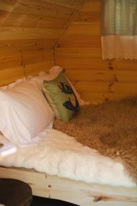 a bed in a room with a pillow on it at Cabane Froggyroom in Vouillé