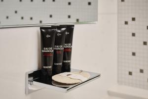 a shelf in a bathroom with two products on it at Mandarin Oriental, Paris in Paris +95 photos