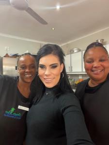 three women posing for a picture in a kitchen at Somer Place B&B in Somerset West