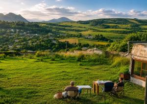 two people sitting at a table in a field at Bears and Berries in Berd