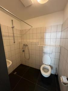 a bathroom with a toilet and a shower at CoolApart in Augsburg in Augsburg