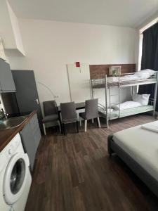 a room with a bed and a table and chairs at CoolApart in Augsburg in Augsburg