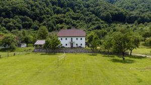 an aerial view of a white house in a field at Bujtina Mitaj in Vermosh