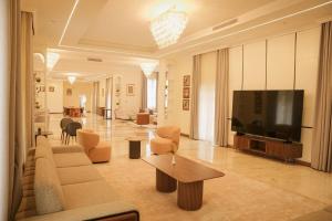 a living room with a couch and a flat screen tv at Jimma Palace Hotel in Jīma