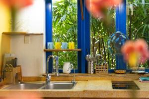 a kitchen with a sink and a window with plants at Loft House 2BR Beachside An Bang Beach Hoi An by Beachside Boutique Homes in An Bàn (2)