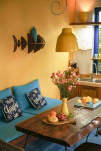 a living room with a table and a blue couch at Loft House 2BR Beachside An Bang Beach Hoi An by Beachside Boutique Homes in An Bàn (2)