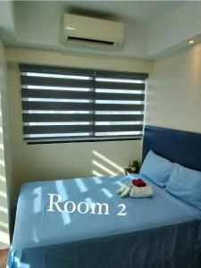 a bedroom with a bed with room written on it at R2 condotel 2BR Santorini tower in Cainta +4 photos