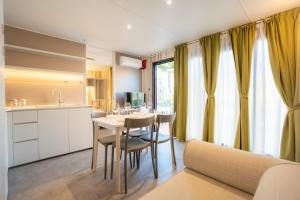 a kitchen and dining room with a table and chairs at Residence Holidays in Pietra Ligure
