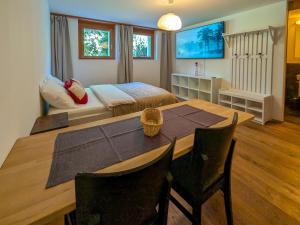 a bedroom with a bed and a table and chairs at PlanB Stay in Silvaplana