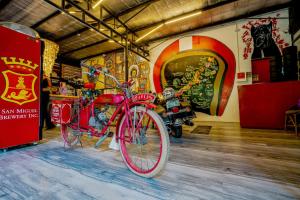 a red bike is parked in a room at Cafe Moto Hostel in Puerto Princesa City