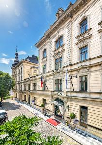 a building with two flags on the side of it at Le Palais Art Hotel Prague in Prague