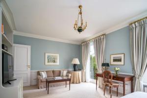 a living room with a couch and a table at Brenners Park Hotel & Spa, Oetker Hotels in Baden-Baden